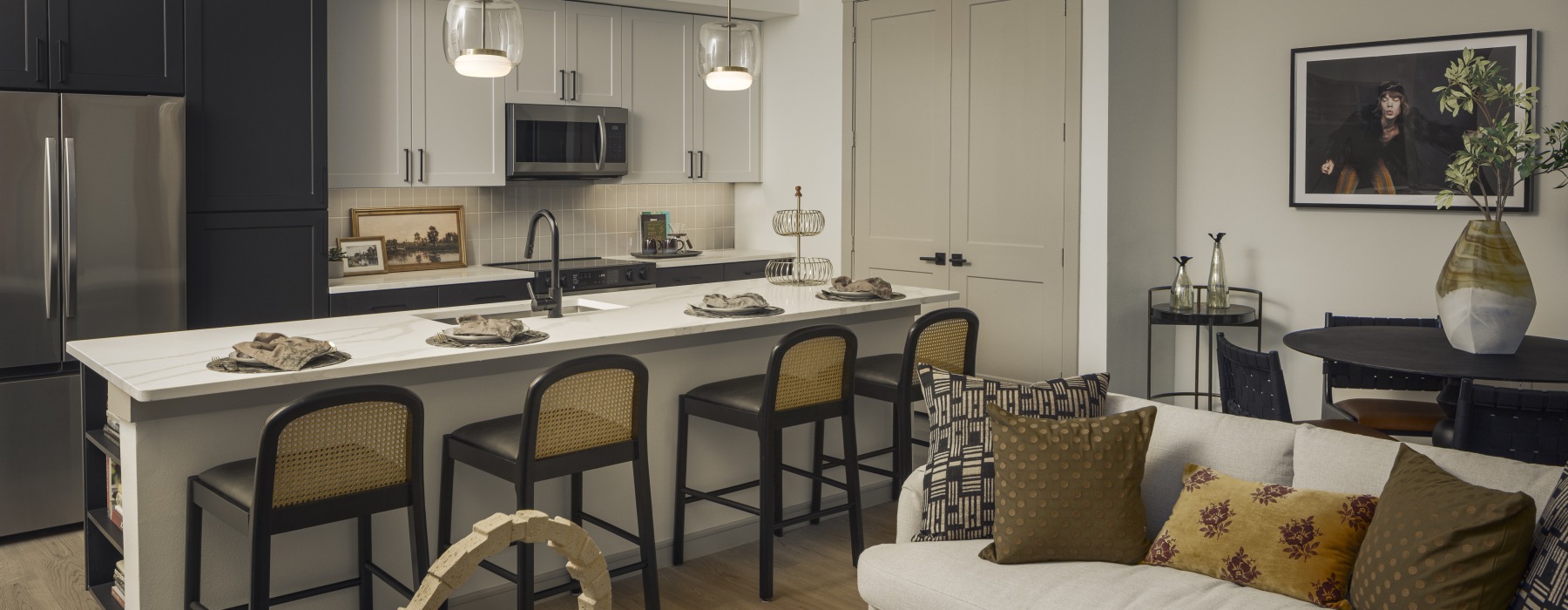 Living  looking into kitchen with large islanc and space for a dining table