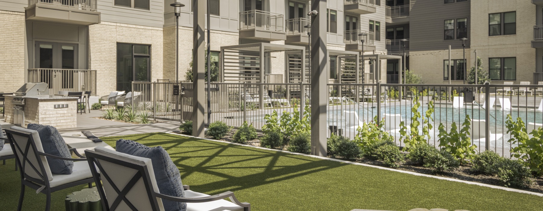 Outdoor space with seating, Outdoor Grills, Cornhole, overlooking the pool 